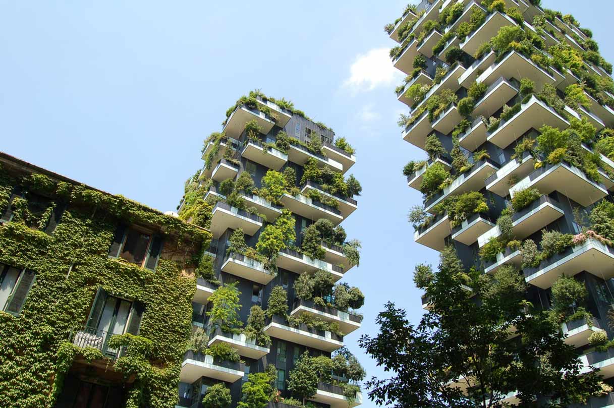 Two tower blocks covered in lush greenery towering into the sky