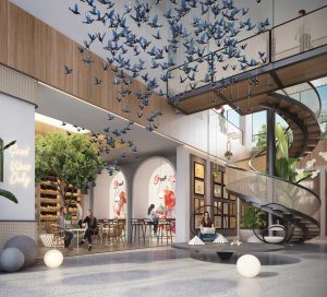 blue glass birds hanging from ceiling of bright clubhouse lobby